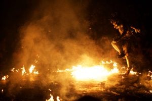 Bali, Indonesia - June 5, 2013: Traditional Balinese Kecak dance white monkey Hanuman in fire at Uluwatu Temple