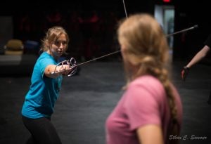 2 females sword fighting