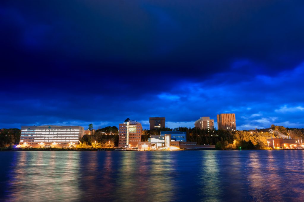 A view of campus at night from across the Keweenaw Waterway.